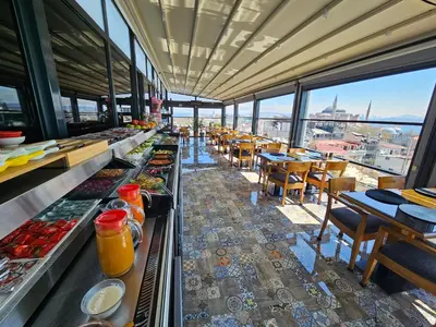 a restaurant with a buffet line with tables and chairs at Anthemis Hotel in Istanbul