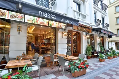 a restaurant with tables and chairs in front of a building at Anthemis Hotel in Istanbul