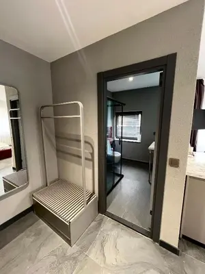a room with a mirror and a room with a bed at Abone Suites in Istanbul
