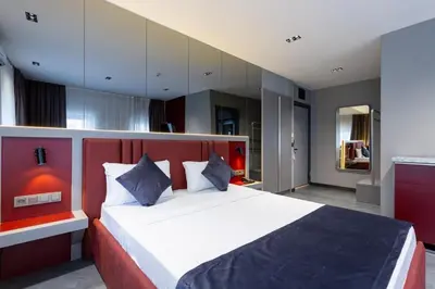 a bedroom with a large bed with a red headboard at Abone Suites in Istanbul