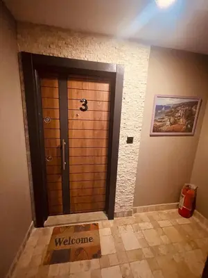 a wooden door in a room with a tile floor at Country , two bedroom and livingroom on Main Street in Çekmeköy