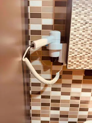 a phone on a tiled wall in a bathroom at Country , two bedroom and livingroom on Main Street in Çekmeköy