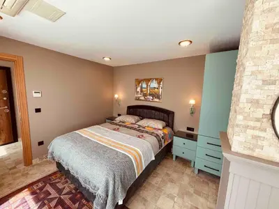 a bedroom with a bed and a nightstand with a bed sidx sidx sidx sidx at Country , two bedroom and livingroom on Main Street in Çekmeköy