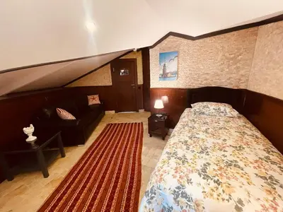 a bedroom with a large bed and a couch at Retro, two bedroom and livingroom on Main Street in Çekmeköy
