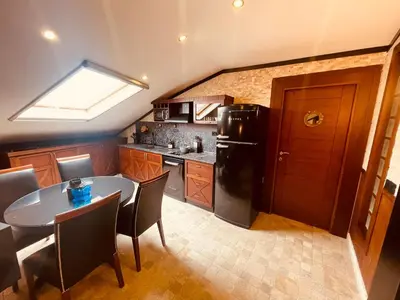a kitchen with a table and a black refrigerator at Retro, two bedroom and livingroom on Main Street in Çekmeköy