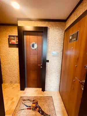 a hallway with a wooden door and a rug at Retro, two bedroom and livingroom on Main Street in Çekmeköy