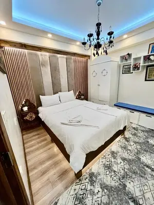 a bedroom with a large bed and a chandelier at Mutlu flat in Istanbul