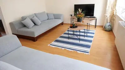 a living room with a couch and a table at Stylish Triplex with Turkish Bath, Terrace, Central Location in Istanbul