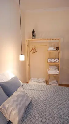 a bedroom with a bed and a shelf with towels at Stylish Triplex with Turkish Bath, Terrace, Central Location in Istanbul