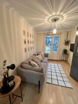 a living room with a couch and a table at Stylish Triplex with Turkish Bath, Terrace, Central Location in Istanbul