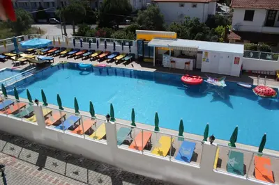 an overhead view of a large swimming pool with chairs at Aydın Motel in Marmara