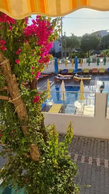a view of the pool at a resort with flowers at Aydın Motel in Marmara