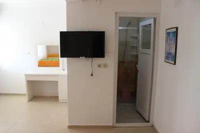 a flat screen tv on a wall in a room at Aydın Motel in Marmara