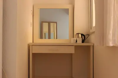 a dressing table with a mirror on top of it at Aydın Motel in Marmara