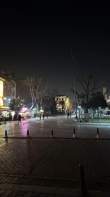 a city square at night with people walking around at Golden Wood Suites in Istanbul