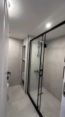 a bathroom with a glass shower with a toilet at Golden Wood Suites in Istanbul