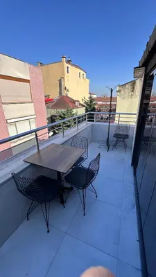 a patio with a table and chairs on a balcony at Golden Wood Suites in Istanbul