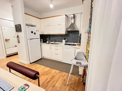 a kitchen with white cabinets and a white refrigerator at Central Apartment Close to Galataport in Istanbul