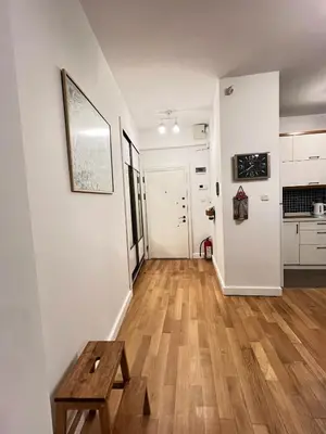 a living room with white walls and a wooden floor at Central Apartment Close to Galataport in Istanbul