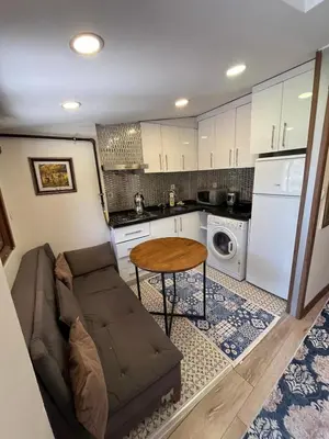 a living room with a couch and a table in a kitchen at Mutlu terrace in Istanbul