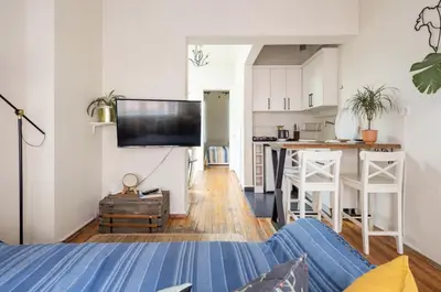 a living room with a blue couch and a kitchen at House of Soul & Triplex with a Winter Garden in Istanbul