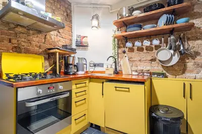a kitchen with yellow cabinets and a stove at House of Soul & Triplex with a Winter Garden in Istanbul