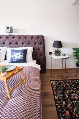 a bedroom with a large bed and a table at Cozy Penthouse with the Balcony in Istanbul