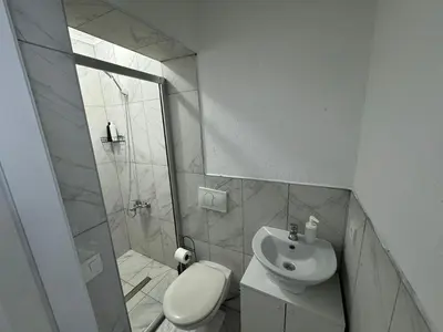 a bathroom with a shower and a toilet and a sink at Istanberry - Scarlet Apartments in Istanbul