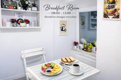 a breakfast room with a table with a plate of food at Istanberry - Scarlet Apartments in Istanbul