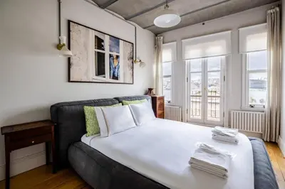 a bedroom with a large white bed and windows at Stunning New Balat Water Front Pad! #383 in Istanbul