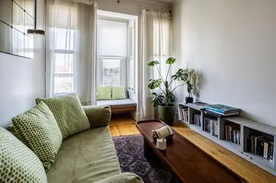 a living room with a couch and a book shelf at Stunning New Balat Water Front Pad! #383 in Istanbul