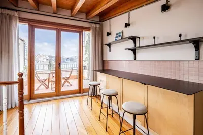 a kitchen with stools and a counter with a balcony at Stunning New Balat Water Front Pad! #383 in Istanbul