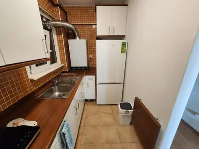 a small kitchen with a refrigerator and a sink at Stunning 1BR w Sea View close to Galataport ! in Istanbul