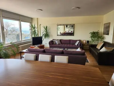 a living room with a couch and a table at Stunning 1BR w Sea View close to Galataport ! in Istanbul