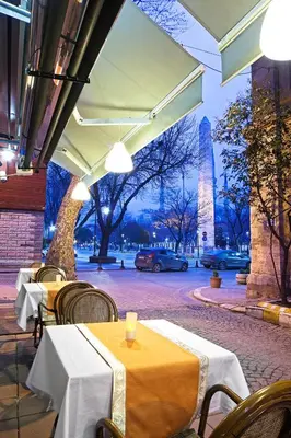a restaurant with tables and chairs on a street at Hotel Spectra Sultanahmet in Istanbul