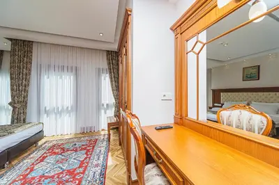 a bedroom with a mirror and a bed and a desk at Hotel Spectra Sultanahmet in Istanbul