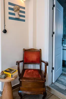 a chair sitting in a room next to a table at Rum Otto Enjoy Relax 30 sec to Taksim Bathtub in Istanbul