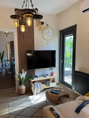 a living room with a flat screen tv on the wall at Rum Otto Enjoy Relax 30 sec to Taksim Bathtub in Istanbul