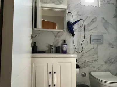 a bathroom with a hairdryer hanging on the wall at Three-room private apartment in Beyoğlu, Central Istanbul in Istanbul