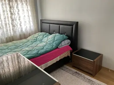 a bed with a wooden headboard and a night stand at Three-room private apartment in Beyoğlu, Central Istanbul in Istanbul