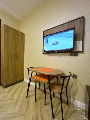 a room with a table and a tv on the wall at Valens Butik in Istanbul