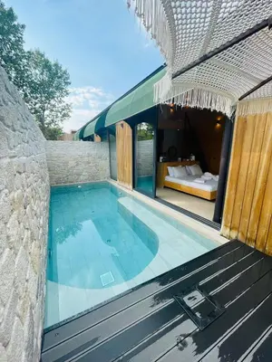 a swimming pool in a house with a stone wall at Prime Suites in Kadıköy