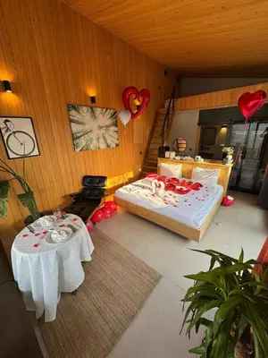 a bedroom with two tables and a bed and balloons at Prime Suites in Kadıköy