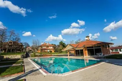 a large swimming pool in a yard with a house at Synosse Park Hotel in Istanbul