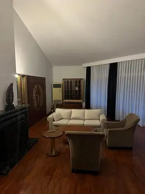 a living room with a white couch and chairs at Synosse Park Hotel in Istanbul