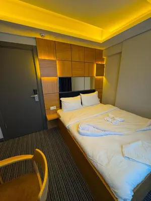 a bedroom with a large bed with a yellow ceiling at Premium Palace in Istanbul