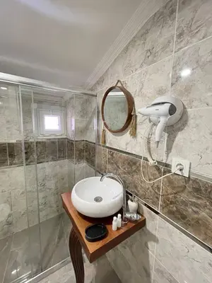 a bathroom with a sink and a mirror at Sevil new apart in Istanbul