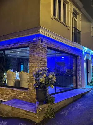 a building with blue lights in front of a building at Sevil new apart in Istanbul