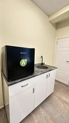 a tv on a counter in a room with a sink at Sevil new apart in Istanbul