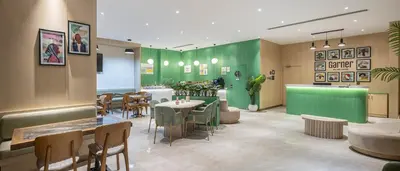 a restaurant with green walls and tables and chairs at Garner Hotel Istanbul - Airport Arnavutkoy by IHG in Istanbul